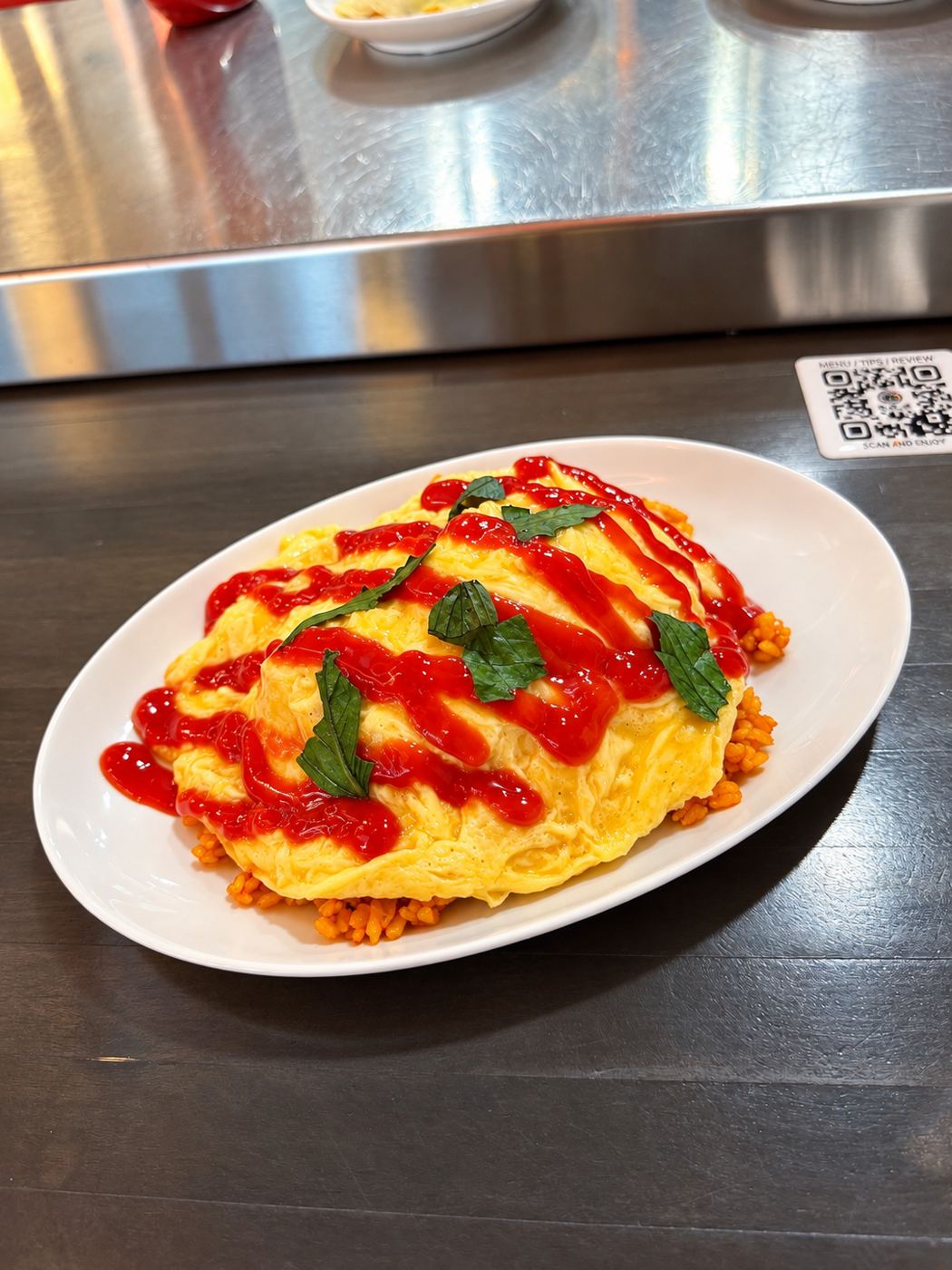 Omurice with ketchup and herbs